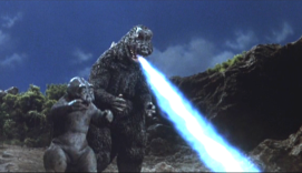 Godzilla shows Minira how to shoot atomic fire